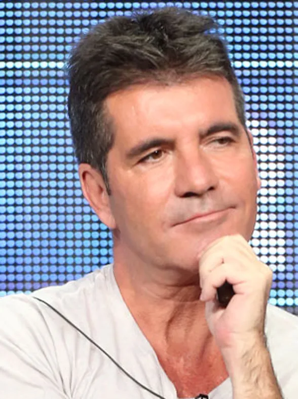 Simon Cowell brushes off baby rumours at One Direction concert