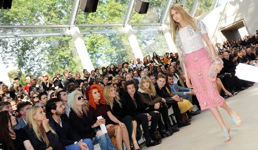 Harry Styles watches Cara Delevingne model for Burberry