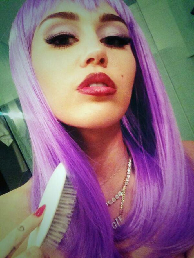 Miley Cyrus as Lil' Kim