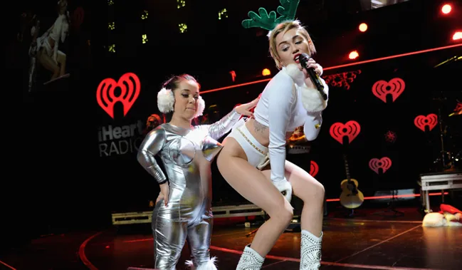 Miley Cyrus has the Holiday spirit: Star passes out in Christmas card photo after Jingle Ball